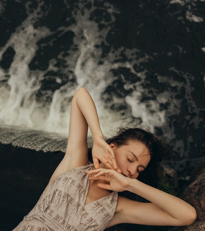 A serene person with closed eyes, focusing inward in a calm environment.